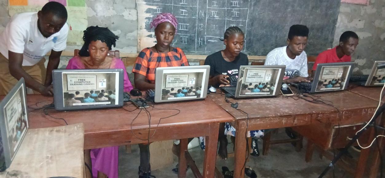 A group of CCAP learners practising computer skills together