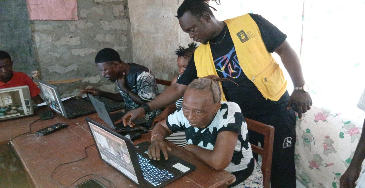 An instructor supporting learners during a computer practice session